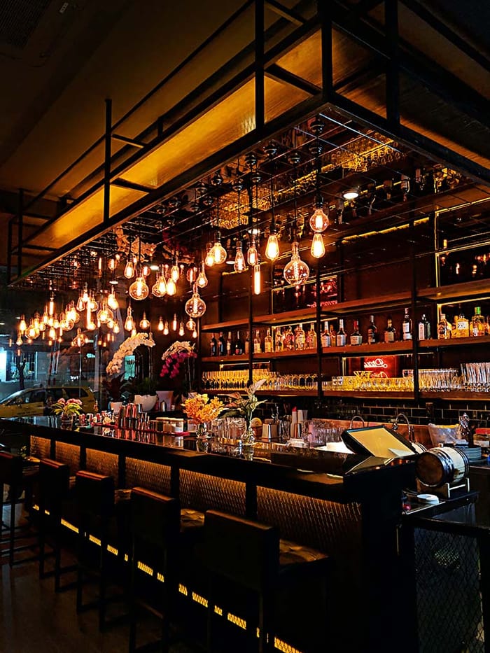 The OneAfrika dining room and bar, warm wood and low, golden light